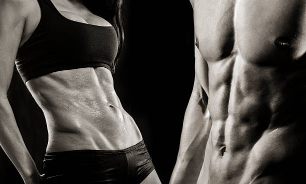 istock Man and woman abs on black background 497809782