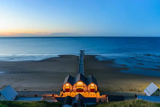 Clifftop view of Pier at twilight time of Saltburn by the Sea, North Yorkshire, UK