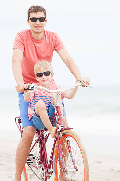istock family biking at the beach 497810554