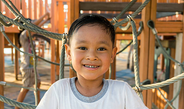 istock Happy asian child playing  on playground 497810694
