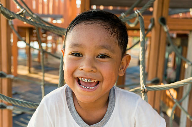 istock Happy asian child playing  on playground 497810748