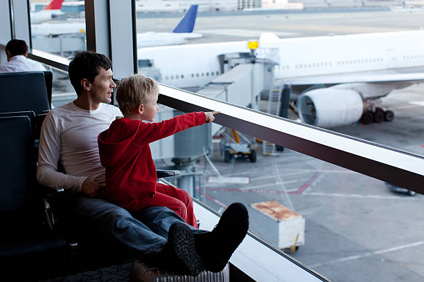 family in airport stock photo