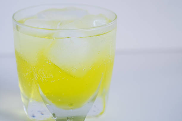 istock Glass of refreshing iced yellow soft drink. 497814268