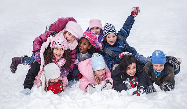 istock Group of playful children having fun on snow. 497827536