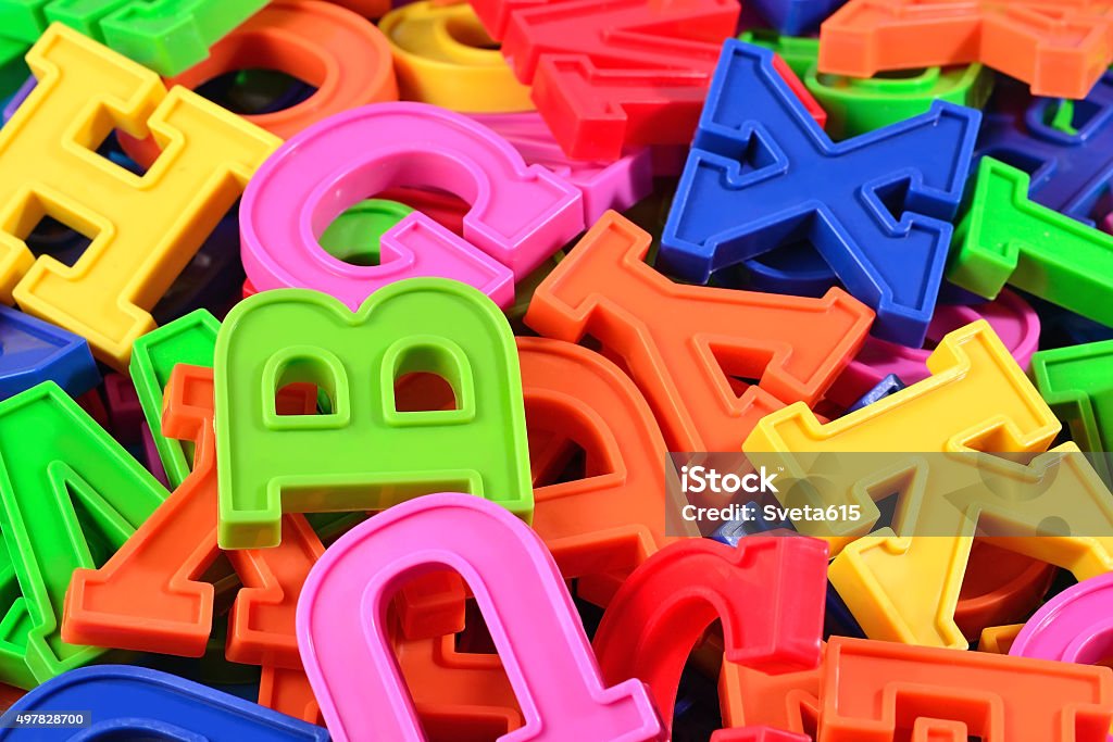 Heap of plastic colored alphabet letters close up Heap of plastic colored alphabet letters close up as background Letter Magnet Stock Photo