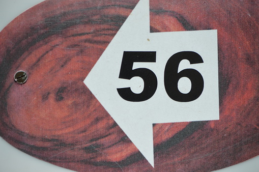 Number 56 is painted on a wood board