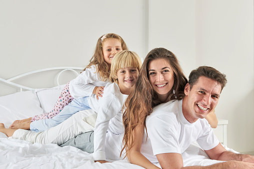 Parents and kids together in bed