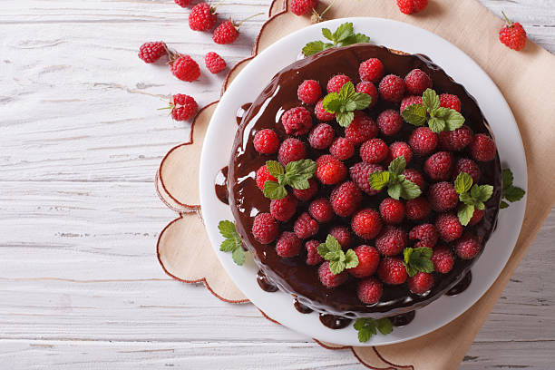 istock Chocolate cake with fresh raspberries and mint. Horizontal top v 497830270