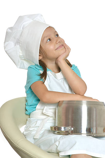 istock Little girl in chef uniform 497830388