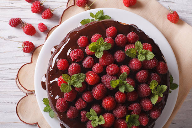 istock Chocolate cake with fresh raspberries and mint close-up. Horizon 497830474