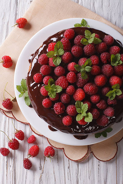 istock Chocolate cake with fresh raspberries and mint vertical top view 497830832