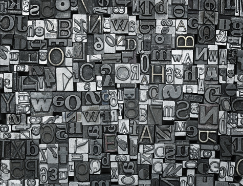 Close up of many old, random metal letters with copy space