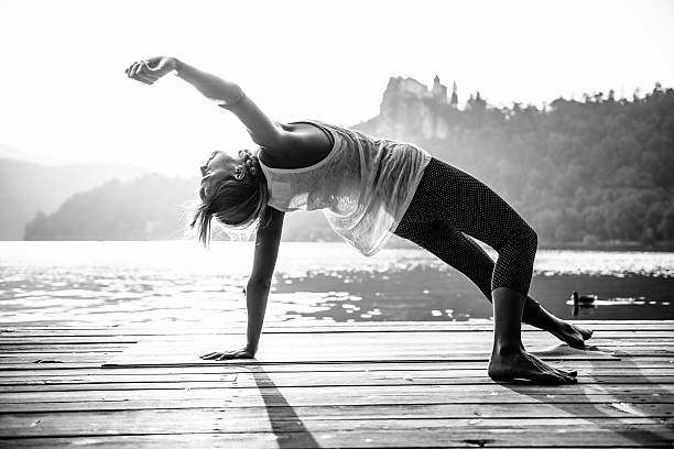 Doing yoga by the lake