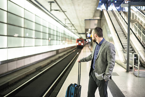 istock businessman waiting the train platform at the station 497833132