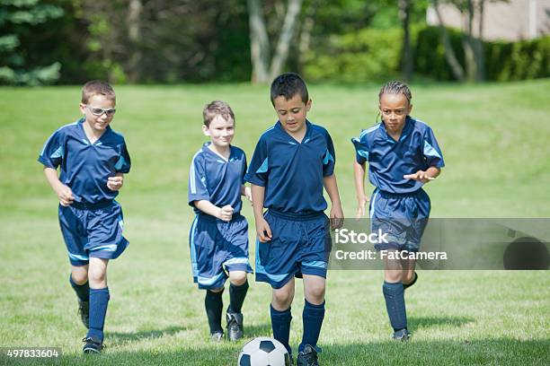 Children Kicking A Soccer Ball Up The Field Stock Photo - Download Image Now - Child, Eyeglasses, Soccer