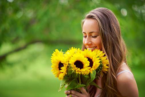 Shot of a young woman holding a bunch of sunflowers outsidehttp://195.154.178.81/DATA/i_collage/pi/shoots/805934.jpg