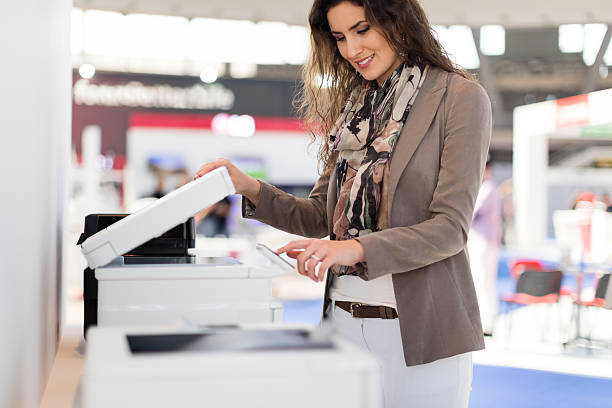 Making copies Smiling woman making copies in office flat bed scanner stock pictures, royalty-free photos & images