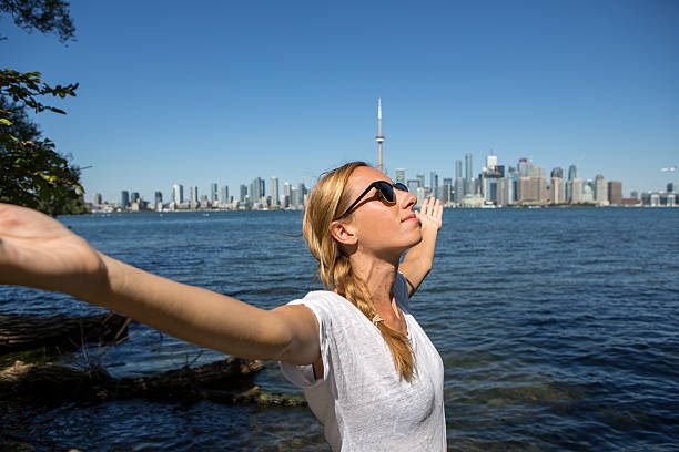 istock Cheering young woman arms outstretched-Toronto 497838944