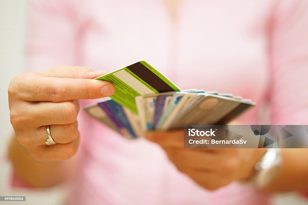 woman choose one credit card, concept of  credit  debt woman choose one credit card from many, concept of  credit card debt, Credit Card Stock Photo