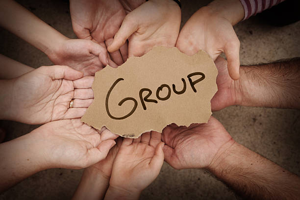istock Group Written on Cardboard Being Held by Several People 497848439