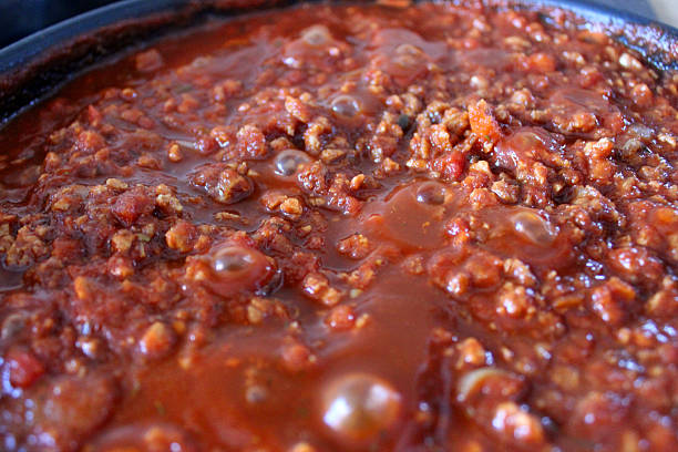 istock Bolognese sauce simmering on cooker, beef mince, pasta sauce image 497848825