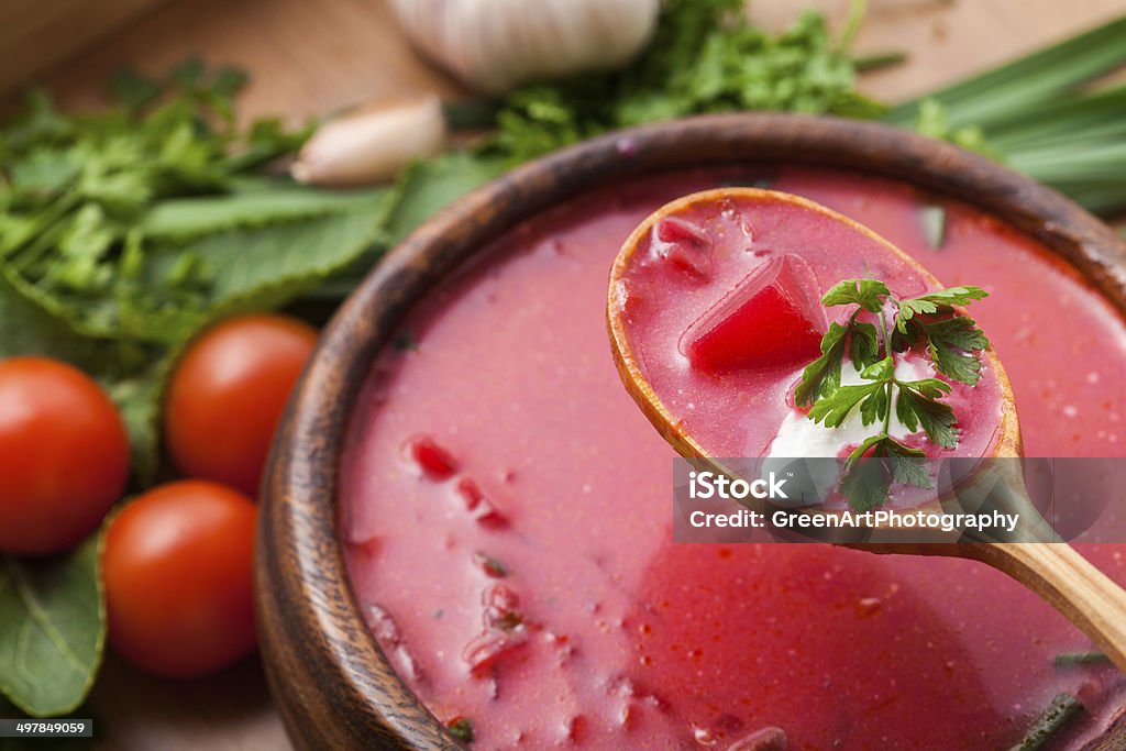 Borsch in a wooden plate Borsch in a wooden plate with a sour cream Carrot Stock Photo