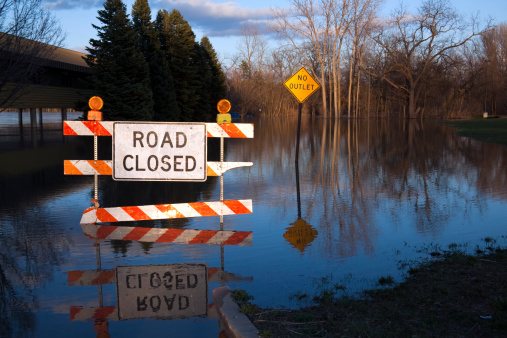 Michigan had 100-year floods not long ago, and here's proof: a Road Closed sign, half submerged with what looks like a lake behind it. It's no lake, just a parking lot. Shot just before dusk, RAW.