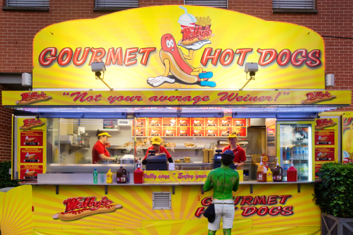 Sydney, Australia - June 15, 2014: A man dressed as The Hulk for pop culture event Supanova makes a purchase from a hot dog stand at Sydney Olympic Park.