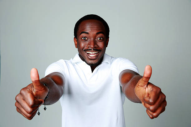 istock Smiling african man showing thumbs up 497851495