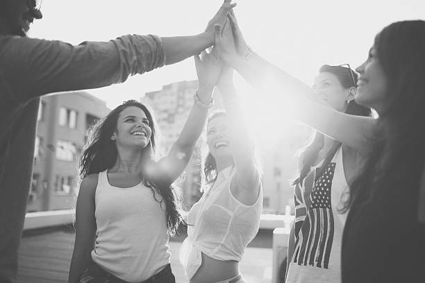 istock Happy friends at the rooftop doing high five 497857576
