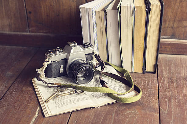 istock Pack of old books with old style camera 497858620