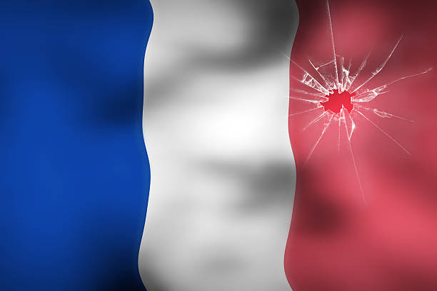 istock French flag behind broken glass with bullet impact background 497859096