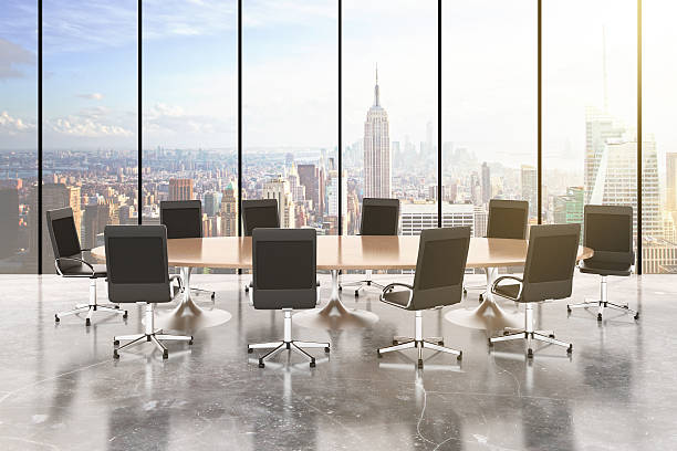 istock Conference room with round table, chairs, concrete floor, window 497859520