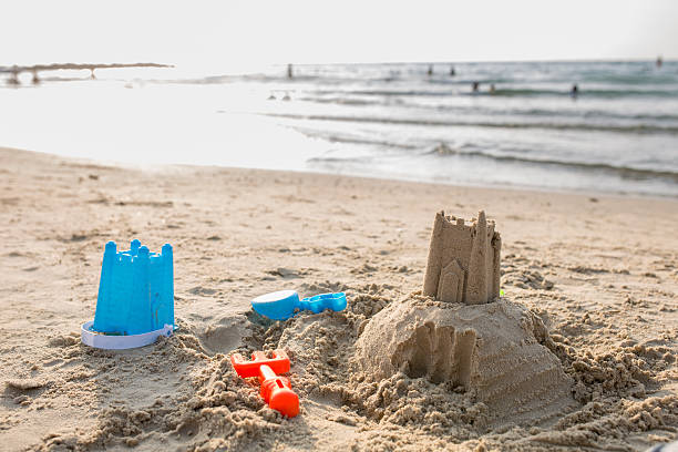 istock Sandcastle and toys on the beach. 497861416