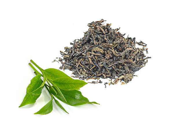 istock dry black tea leaves isolated on white 497861570