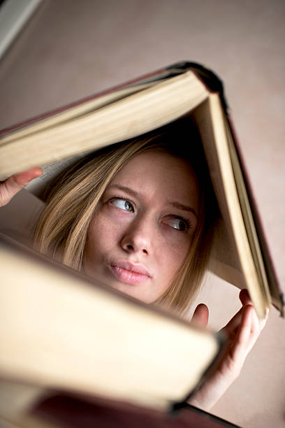 istock Confused woman with book on her head. 497861878