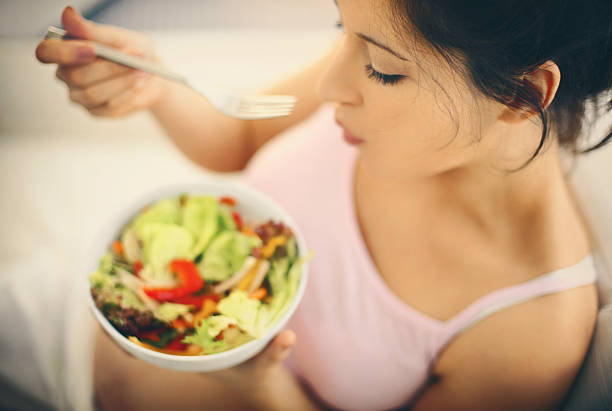 istock Woman eating a salad. 497861976