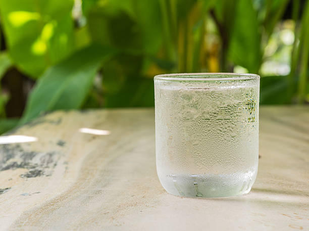 istock Glass cold water on wooden floor. 497863192