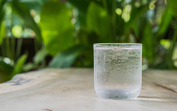 istock Glass cold water on wooden floor. 497863700