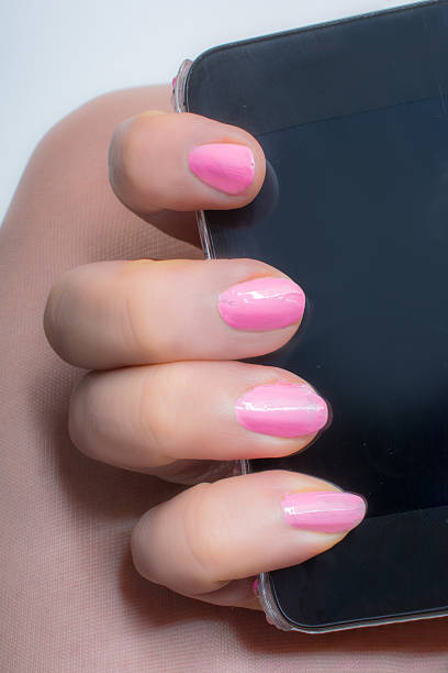 istock smartphone with  in pink manicured hand 497863794
