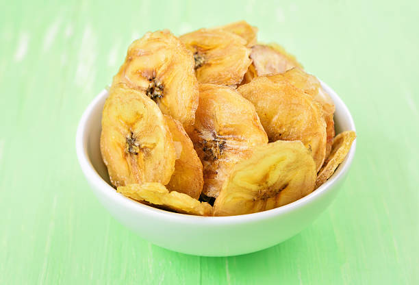 istock Homemade banana chips in white bowl 497865330
