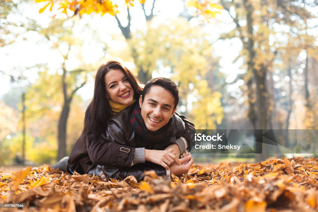 Smiling couple having fun in the park. Autumn is beautiful. 2015 Stock Photo
