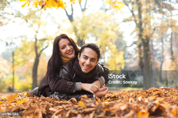 Smiling Couple Having Fun In The Park Stock Photo - Download Image Now - 2015, Activity, Adult