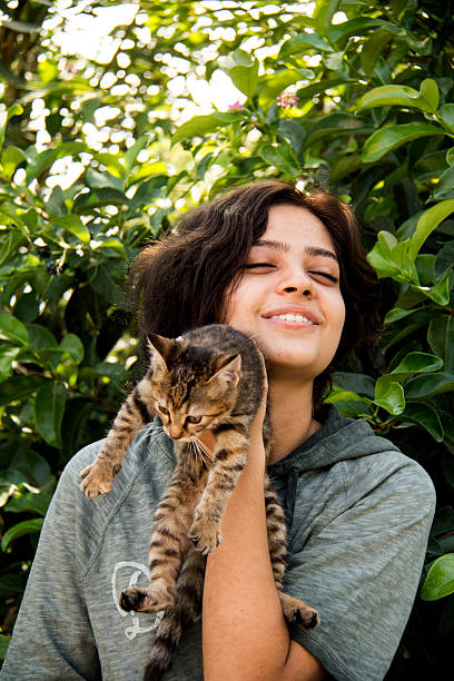 istock Young girl and hungry stray cat. 497867736