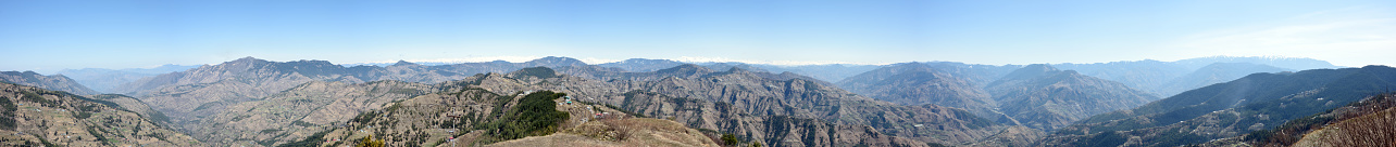A panoramic view of the Himalayas mountain range looking north-east from the village of Fagu near Shimla in the Himachal Pradesh state of India. The mountains in the distance remain snow-covered throughout the year and form the border with Tibet.