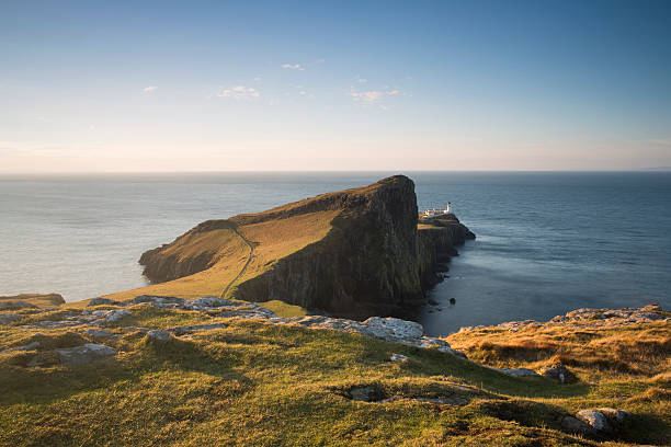 istock cliffs and lighthouse on the coast of scotland at sunrise 497868616