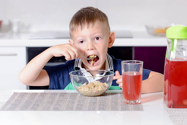 istock Boy Eating Oatmeal Cereal for Breakfast 497868790