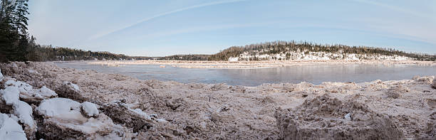 istock Panorama of forest river covered with snow and ice 497890881