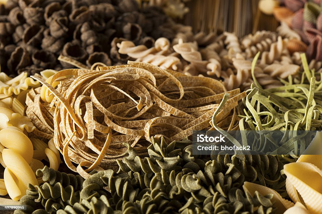 Assorted Homemade Dry Italian Pasta Assorted Homemade Dry Italian Pasta on a Background Bow Tie Pasta Stock Photo