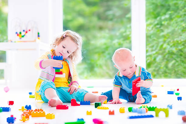 istock Brother and sister playing with colorful blocks 497891653